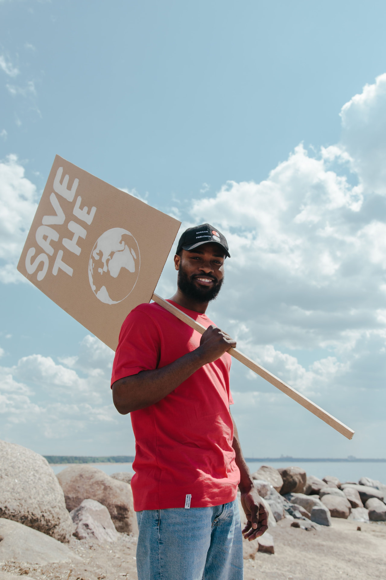A young man holding a Save the Earth placard
