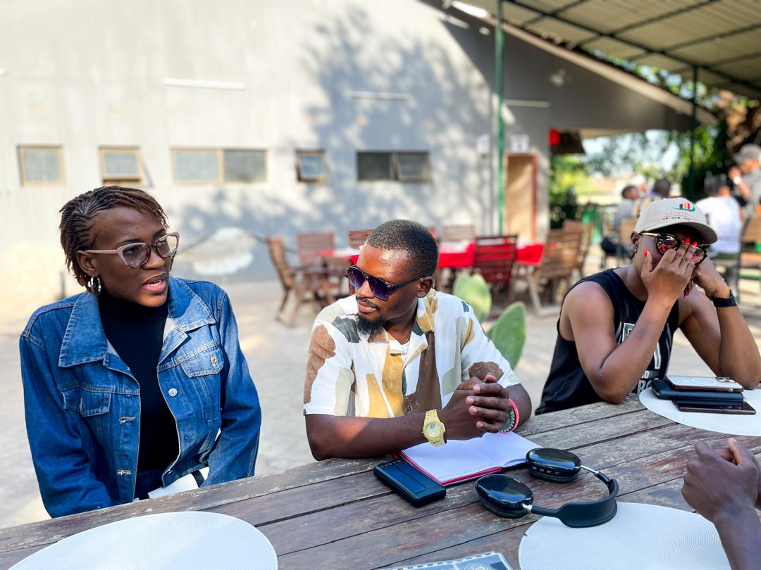 Three people planning together at an outdoor table